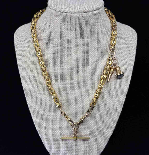 A Late Victorian antique 15ct yellow gold Albert chain featuring a T-Bar and fancy link star set design.