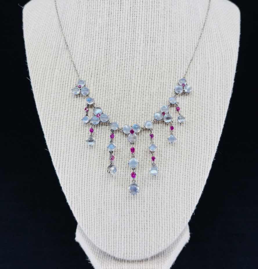Front view of a vintage 1920s moonstone and ruby fringe necklace in sterling silver, showcasing Art Deco elegance.
