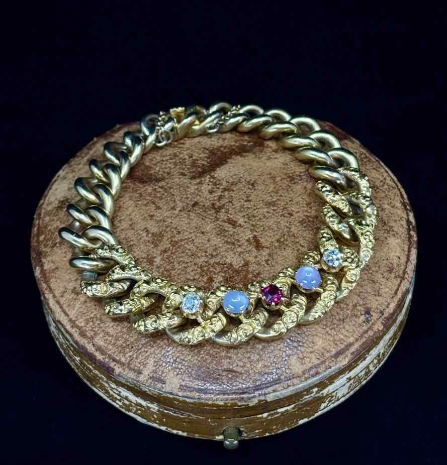 15ct gold antique curb link bracelet showcasing Victorian ruby and star sapphire gems.