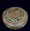 15ct gold antique curb link bracelet showcasing Victorian ruby and star sapphire gems.
