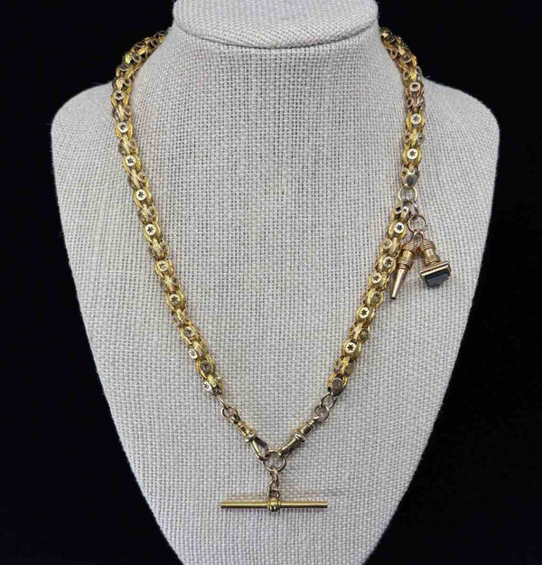A Late Victorian antique 15ct yellow gold Albert chain featuring a T-Bar and fancy link star set design.