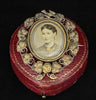 15ct yellow gold revolving locket by Lamborn and Wagner with intricate vine leaves.
