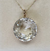 Front view of an antique Victorian rock crystal pendant with a high-domed faceted round crystal in 9ct yellow gold