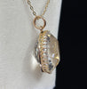 Side view of the antique Victorian rock crystal pendant highlighting the domed profile and scalloped 9ct gold gallery
