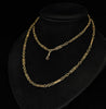 Antique Edwardian 9ct gold guard chain displayed long and doubled on a black stand, showing its original swivel clip