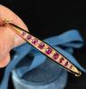 Circa 1895 vintage ruby and diamond bangle, oval rubies with diamond accents in 15ct gold