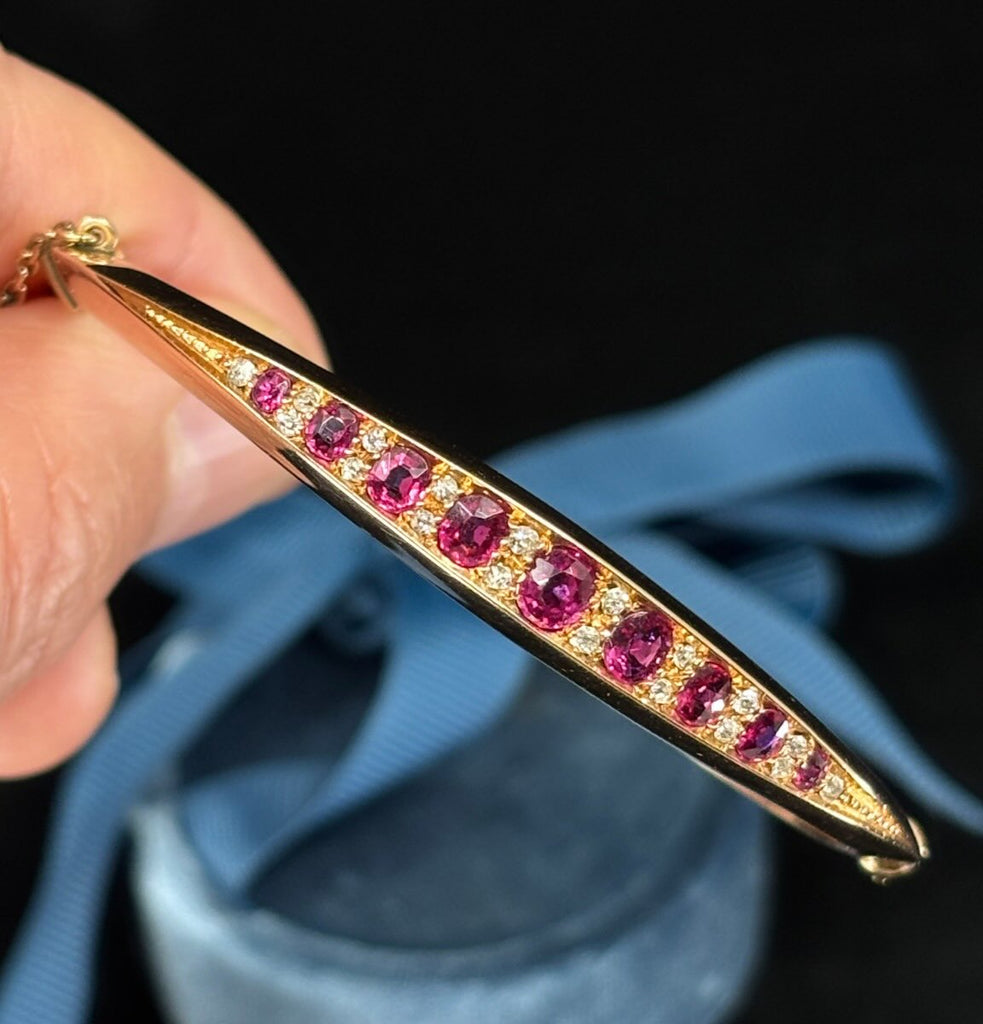 Circa 1895 vintage ruby and diamond bangle, oval rubies with diamond accents in 15ct gold