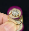 a side view showcasing the intricate 18ct yellow gold gallery of the flower cluster ring