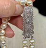 1920s Art Deco Akoya pearl necklace with intricate diamond clasp.