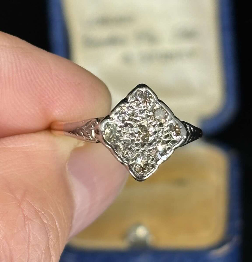 1920s Art Deco Diamond Cluster Ring highlighting unique geometric shapes and sparkling diamonds.