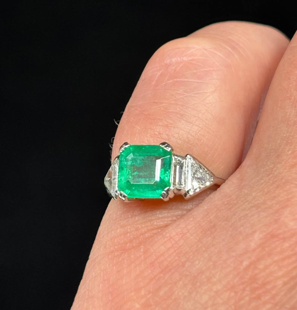 1930s Art Deco vintage emerald engagement ring, 1.25ct center emerald with G-colour shield and baguette diamonds.