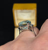 1950s emerald-cut aquamarine engagement or statement ring in 18ct white gold, greenish-blue hue, medium clarity, no heat indications.