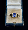 Vintage 1970s gold signet ring with a blue sapphire in a ring box.