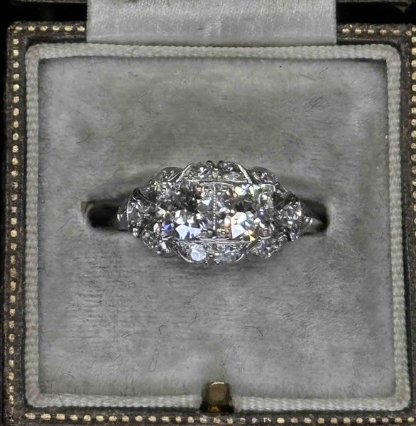 Front view of an Art Deco diamond cluster ring with twin Old European cut centres, single-cut halo and platinum band