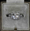 Front view of an Art Deco diamond cluster ring with twin Old European cut centres, single-cut halo and platinum band