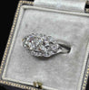 Angled view of the Art Deco diamond cluster ring showing toi et moi diamonds, milgrain borders and a pierced platinum gallery