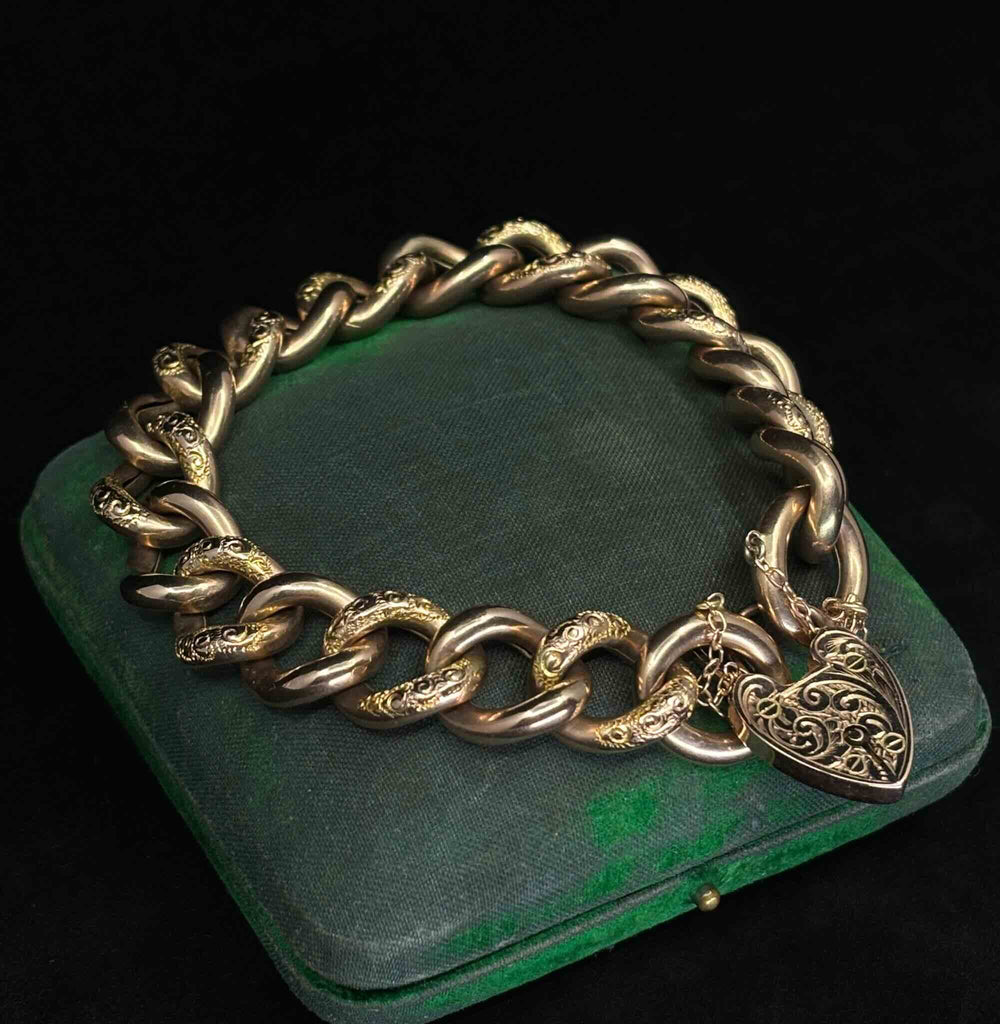 Antique Victorian rose gold bracelet showing engraved curb links, heart padlock clasp and safety chain