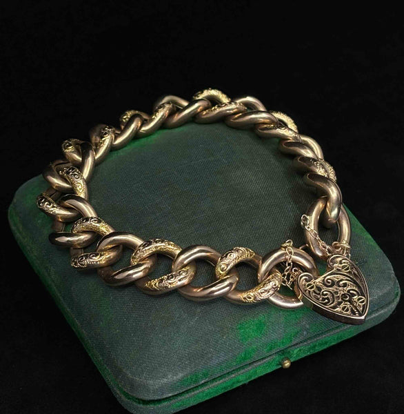 Antique Victorian rose gold bracelet showing engraved curb links, heart padlock clasp and safety chain