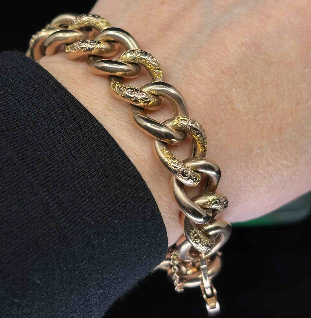 Antique Victorian rose gold bracelet worn on the wrist, highlighting alternating polished and hand-engraved curb links