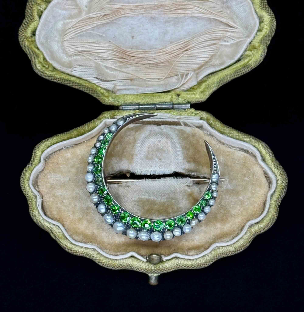 Front display view of the Victorian gold crescent moon brooch set with green demantoid garnets and natural pearls