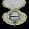 Front display view of the Victorian gold crescent moon brooch set with green demantoid garnets and natural pearls