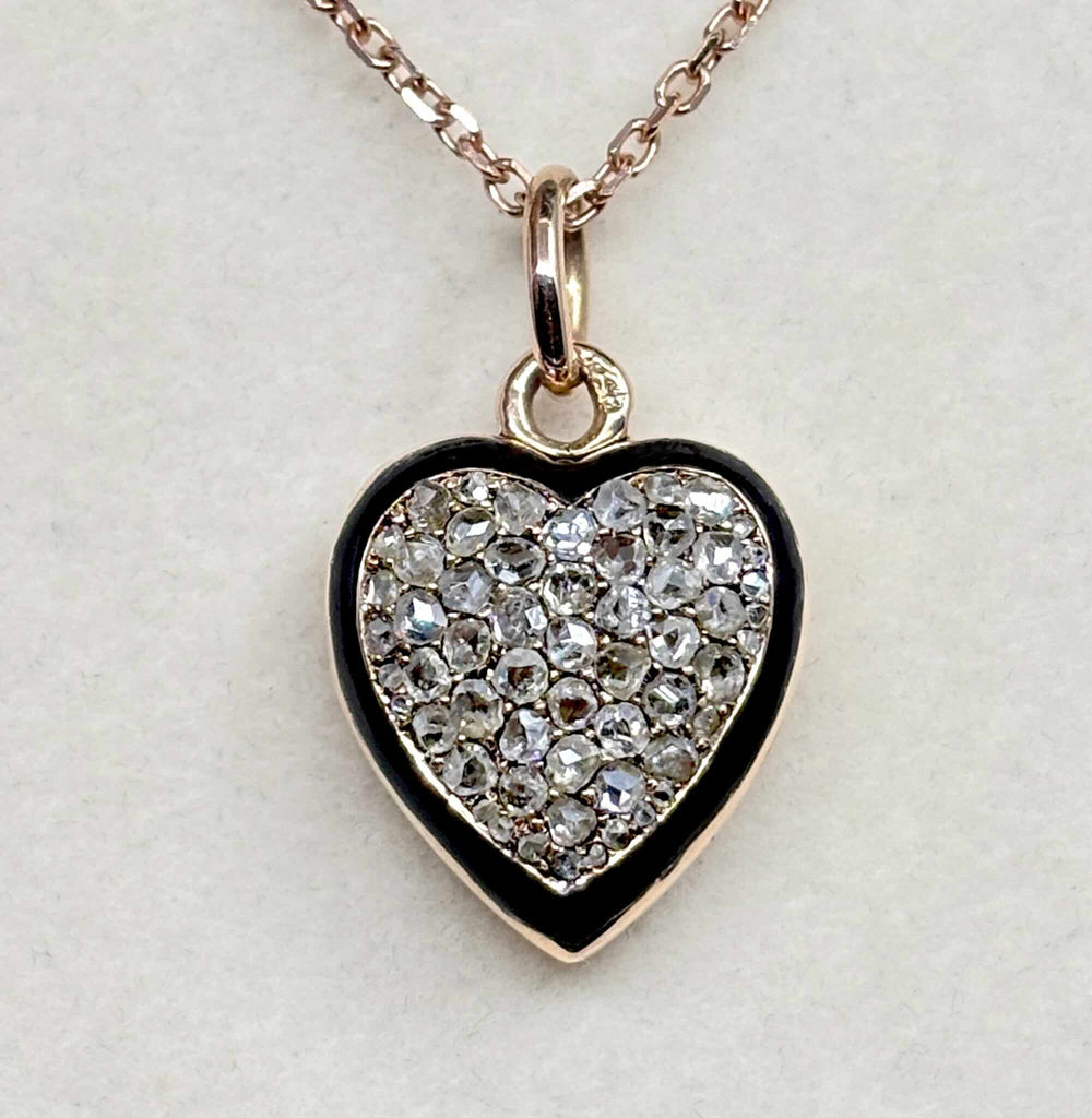 Front view of an antique Victorian diamond heart locket in 15ct rose gold with rose-cut diamonds and black enamel