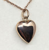 Rear view of the antique Victorian diamond heart locket showing its smooth polished 15ct rose gold back