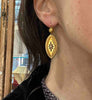 Victorian 15ct yellow gold starburst drop earring worn on the ear, showing its elongated navette shape and 50 mm length