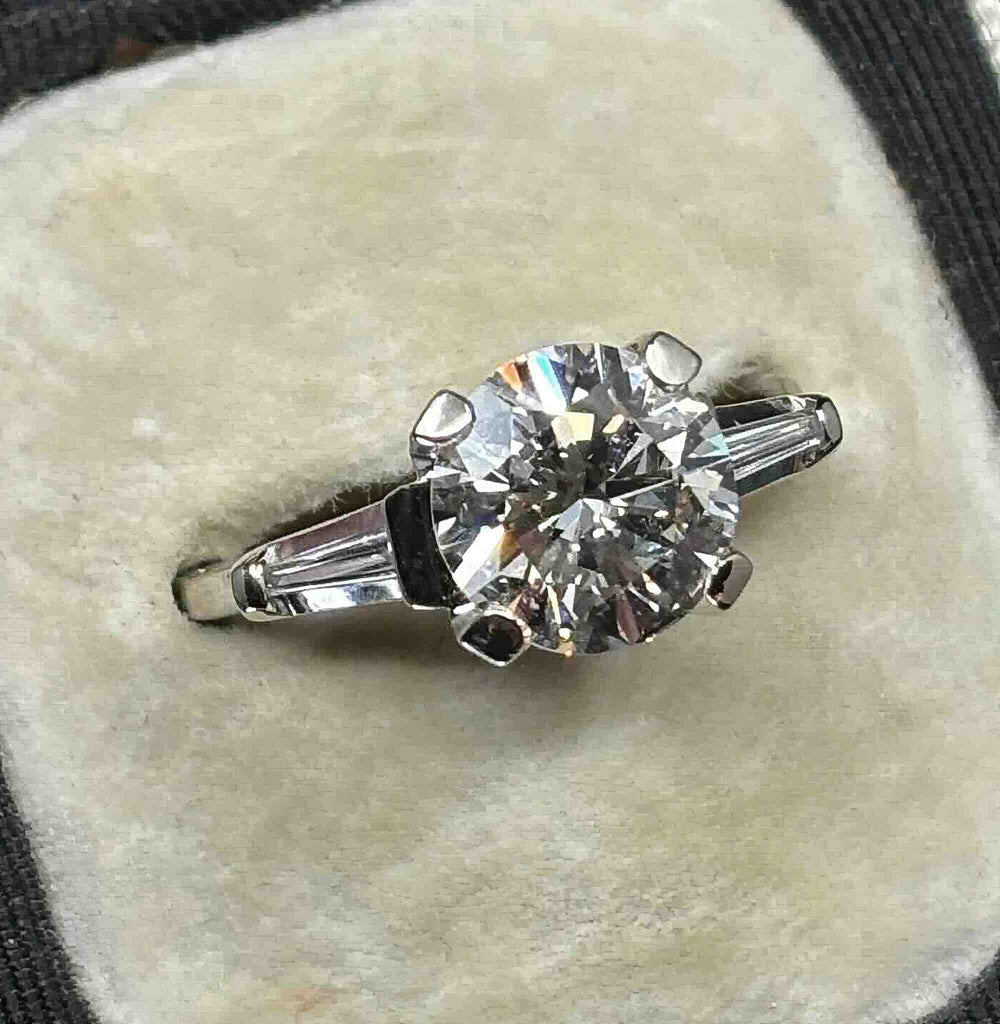 Front view of a vintage 2.43ct diamond engagement ring with a brilliant cut centre and tapered baguette side diamonds