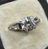 Front view of a vintage 2.43ct diamond engagement ring with a brilliant cut centre and tapered baguette side diamonds