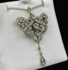 Front view of the antique Victorian diamond pendant brooch with a central Old European cut diamond and five-stone drop