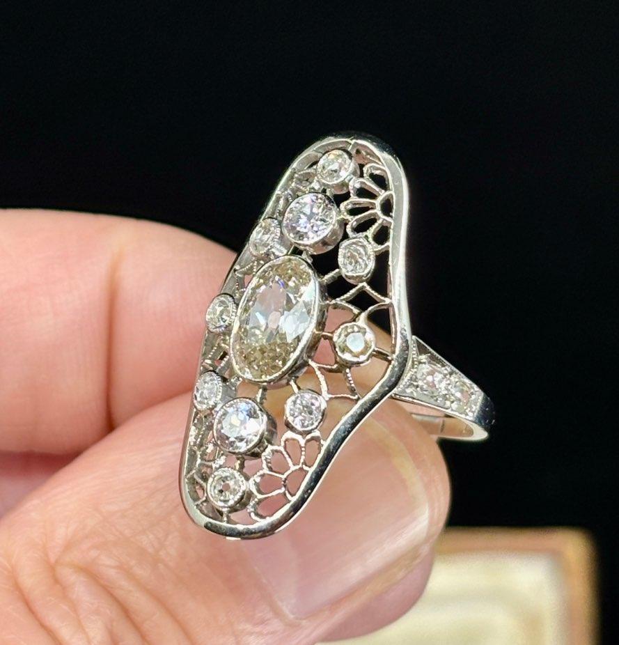 Antique Art Deco diamond openwork plaque ring showcasing intricate design and vintage charm.