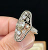 Antique Art Deco diamond openwork plaque ring showcasing intricate design and vintage charm.