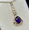 Second side view of the pendant showcasing the rose gold applied leaves and gold fine scroll work against the dark, luminous purple colour of the amethyst