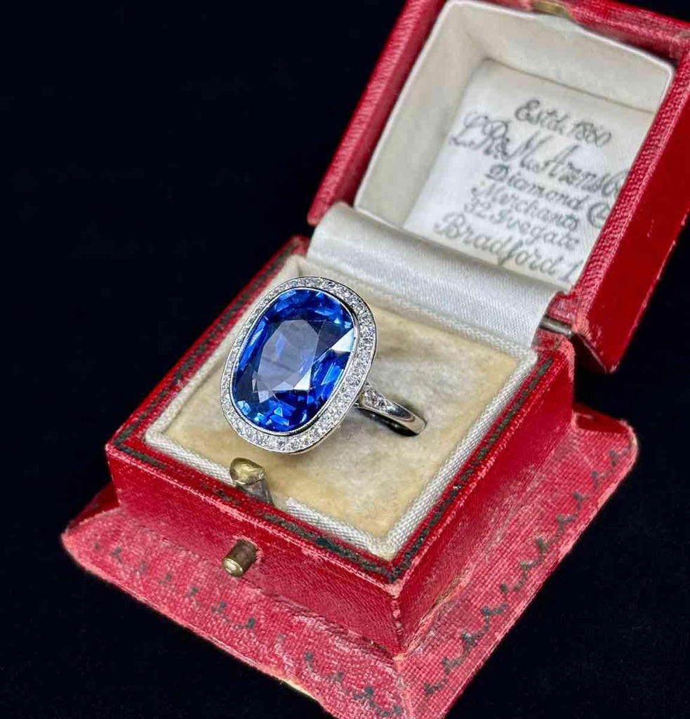 Edwardian-era ring with a deep blue cushion cut sapphire measuring 14.9x11.5x6.8mm, adorned with single cut diamonds.
