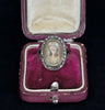 Exquisite Georgian portrait ring from 1810 featuring a painted portrait of an upper-class woman, surrounded by marcasite stones.