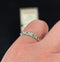 Side view of an antique platinum band with emeralds and diamonds