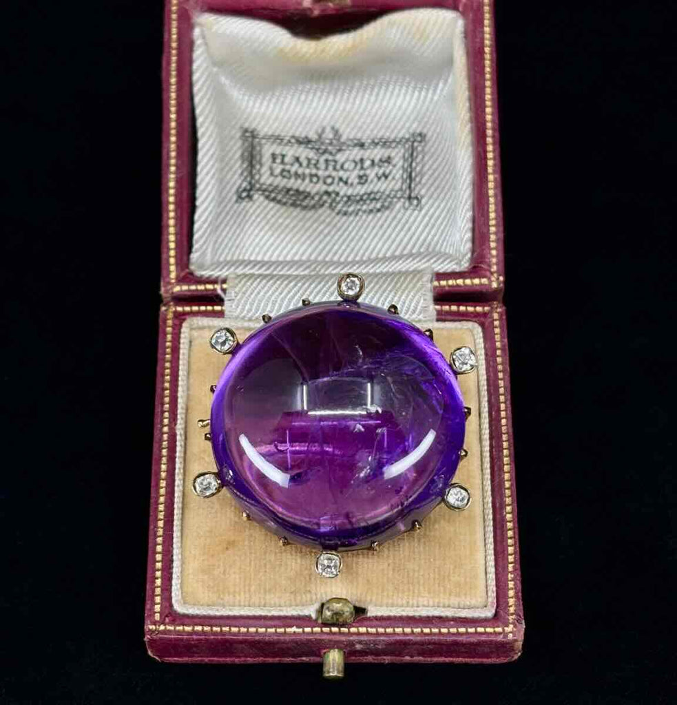 Antique Russian amethyst and diamond brooch from 1890 with intricate gold setting.