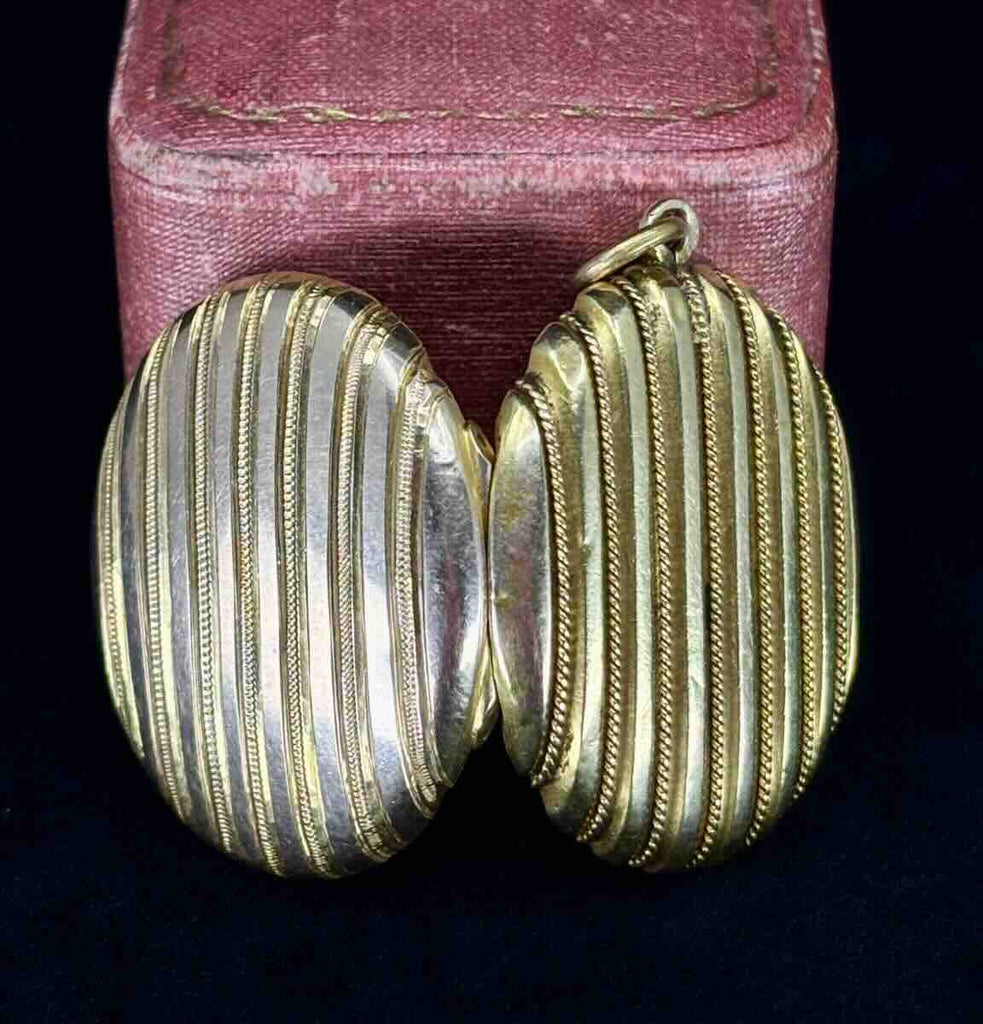 Dual view of the antique Victorian gold oval locket with intricate striped design.