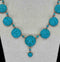 Close-up of the intricate pavé set turquoise stones and alternating small oval turquoise on a Victorian necklace.