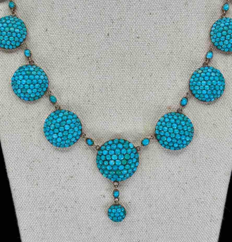 Close-up of the intricate pavé set turquoise stones and alternating small oval turquoise on a Victorian necklace.