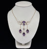Antique Australian amethyst necklace in 9ct yellow gold, featuring three oval amethysts and a natural half pearl, circa 1910.