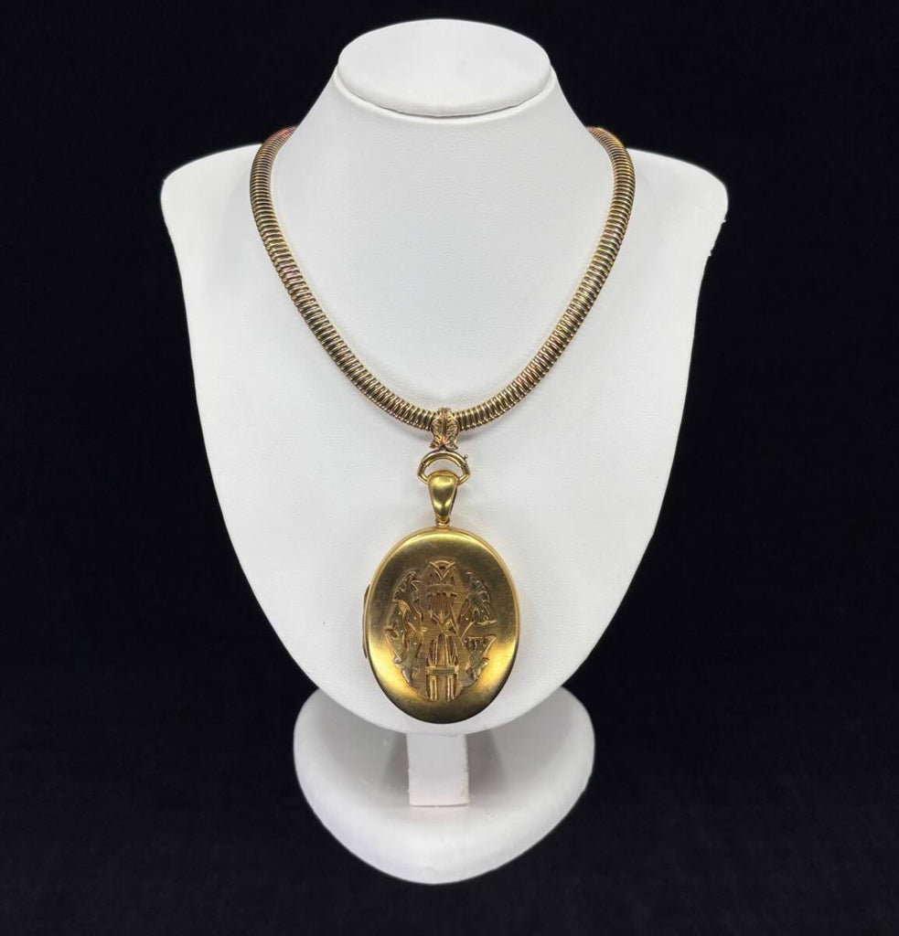The large antique gold oval locket features on a bust on an antique Victorian gold collar