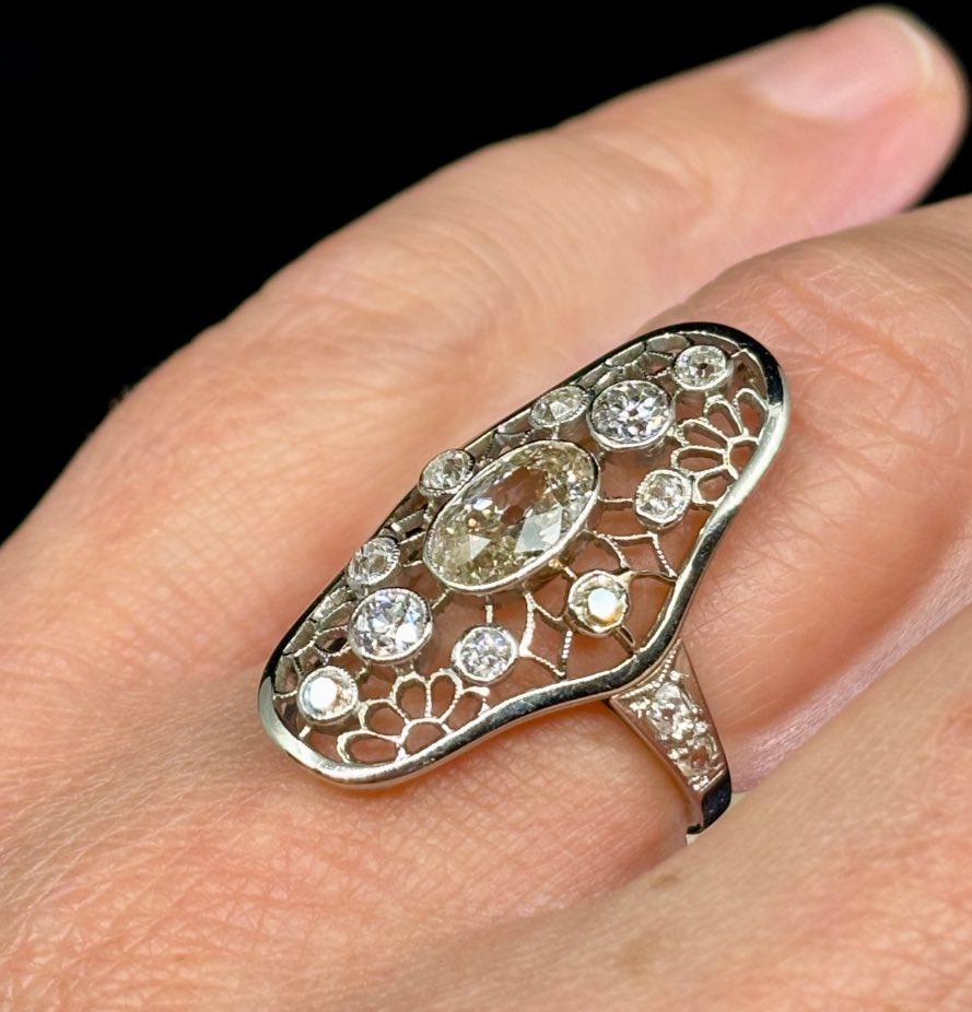 Art Deco diamond ring with openwork design in antique gold, reflecting timeless elegance.