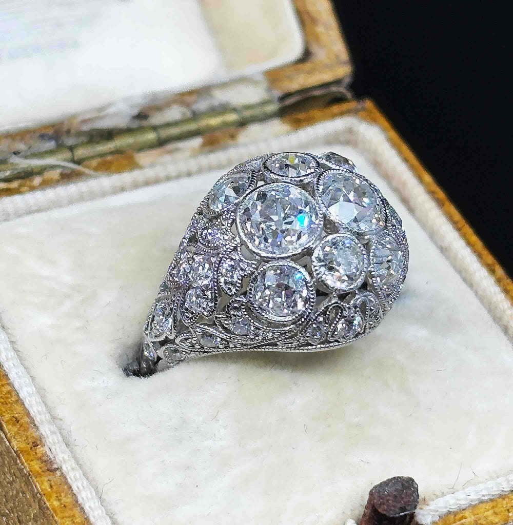 Side oblique view of the Art Deco Platinum 3.59ct Diamond Cluster Ring in a cream antique ring box