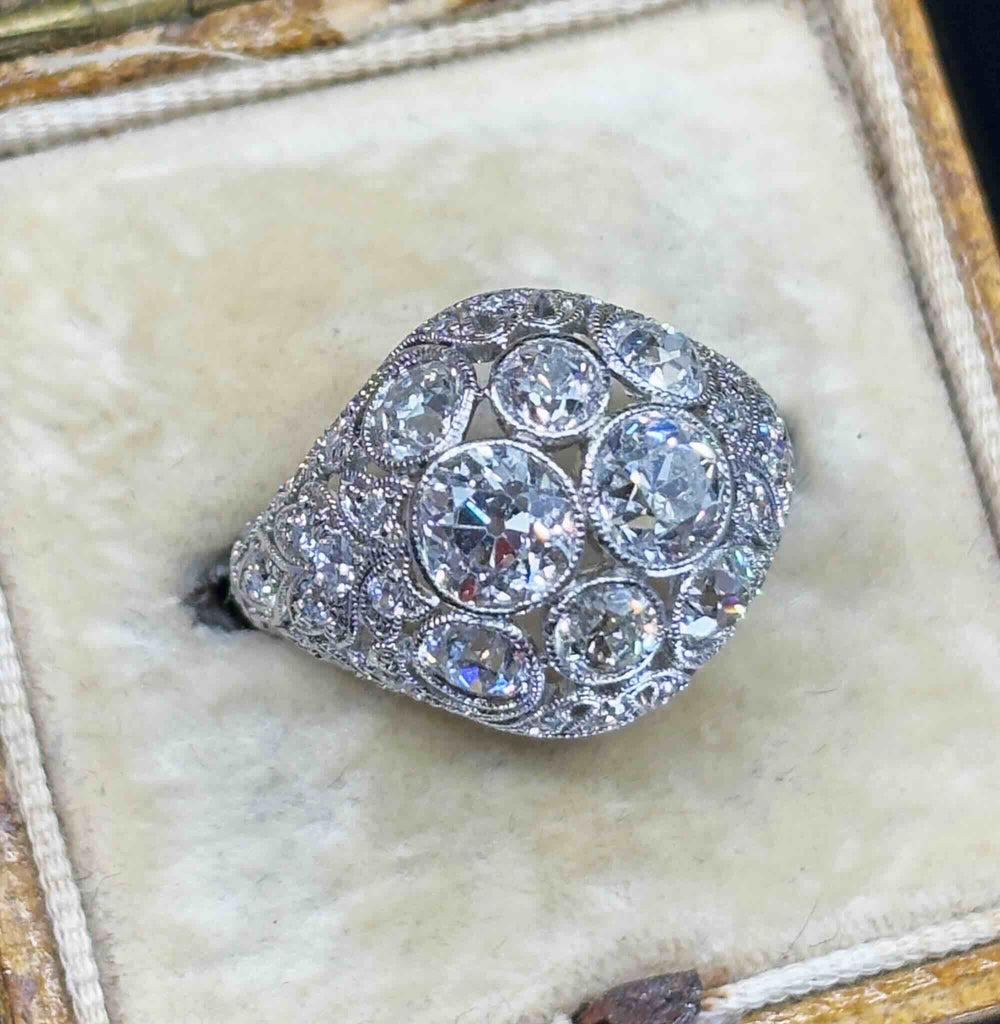 Side view of the Art Deco Platinum 3.59ct Diamond Cluster Ring in a cream antique ring box