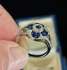Art deco sapphire and diamond cluster ring with 18ct yellow gold engraved under rail.