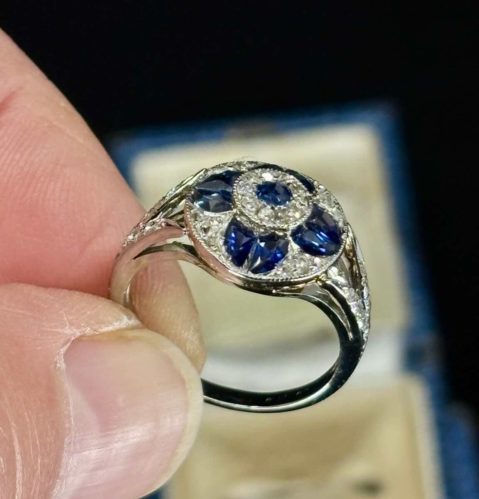 Art deco sapphire and diamond cluster ring with 18ct yellow gold engraved under rail.