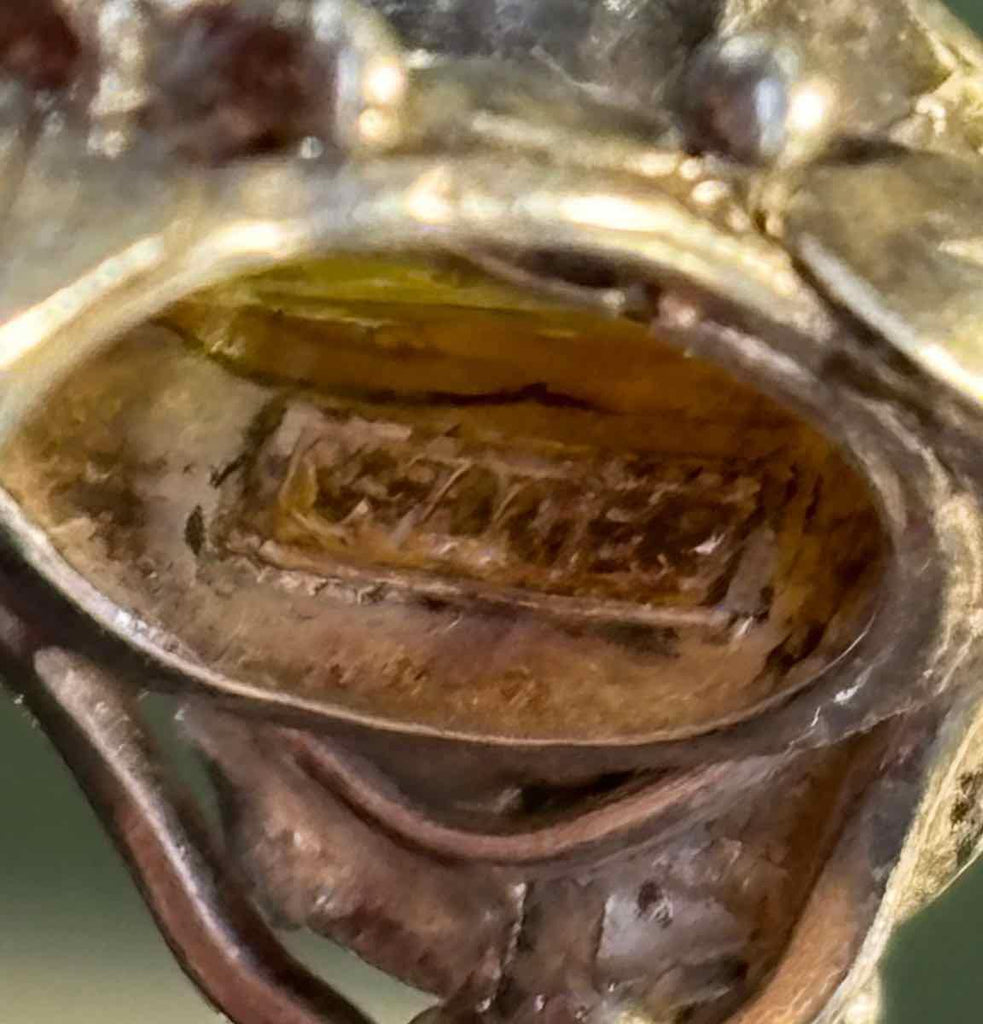 Internal marking of Rhoda Wager stating WAGER in silver underneath citrine bezel.