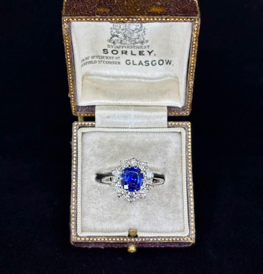 Elegant diamond halo ring with a color change Ceylon sapphire center piece.